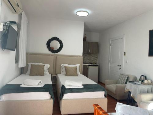 a living room with two beds and a couch at Premium apartments in Ulcinj