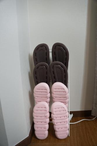 a pair of pink shoes sitting on the floor at Zen house 2 in Okayama