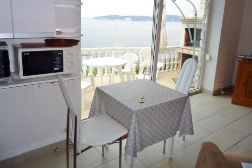a small kitchen with a table and a view of the water at Villa Ana in Savudrija
