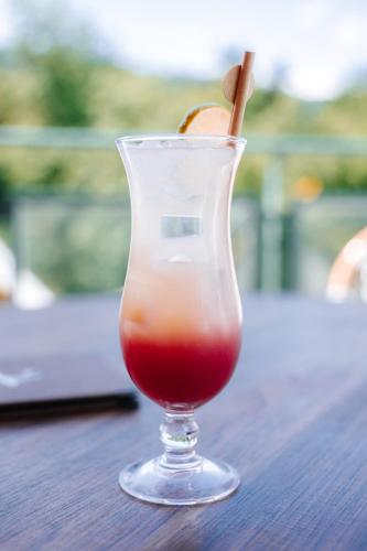 a drink in a glass sitting on a table at Les Violettes Hotel & Spa in Jungholtz