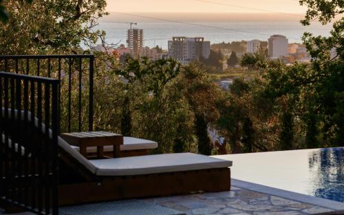 a bench sitting on a balcony overlooking a city at Villa Amara in Bar
