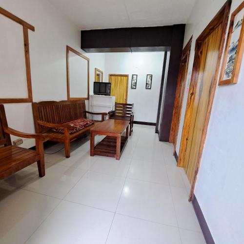 a living room with a couch and a table at Baguio Tourist Cabin in Baguio