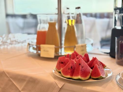 a plate of watermelon slices on a table at Greif Hotel & Spa in Trieste