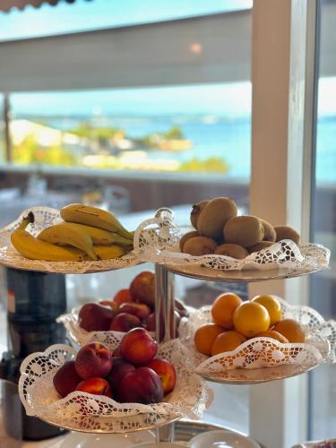 three tiers of fruit on plates with bananas and apples at Greif Hotel & Spa in Trieste