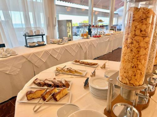 a table with several plates of food on it at Greif Hotel & Spa in Trieste