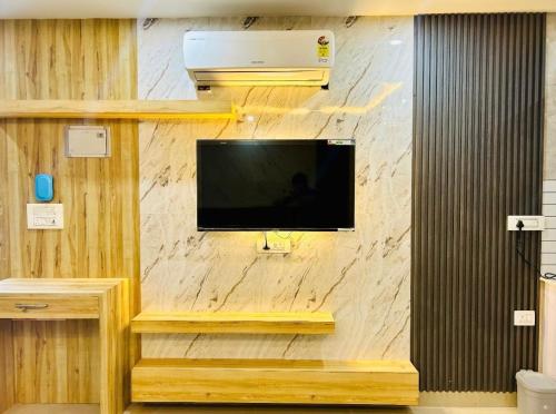 a flat screen tv on a wall at The Haven Suite in Dehradun