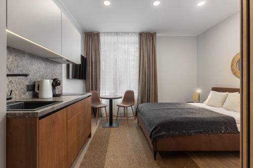 a hotel room with a bed and a sink and a kitchen at P6-A Riga Old Town Apartments in Rīga