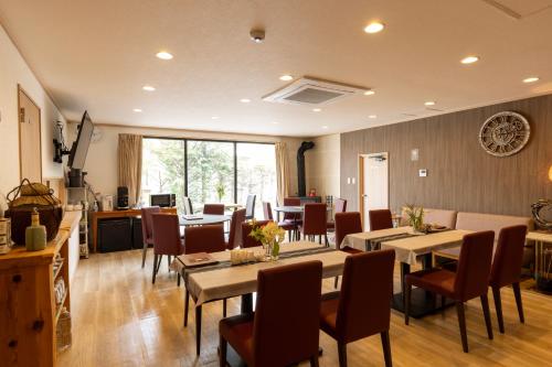 a dining room with tables and chairs and aktop at 軽井沢フォーシーズホテル in Karuizawa