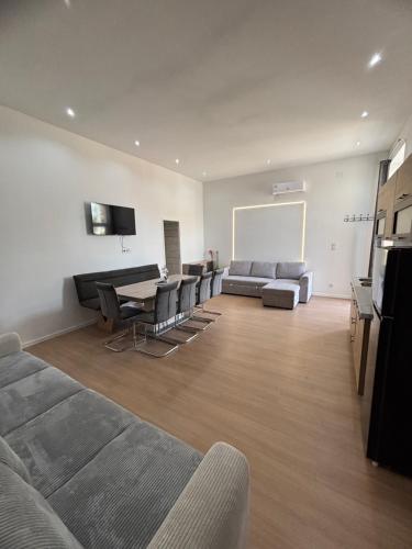 a living room with a couch and a table at Zelia Apartmanház in Siófok