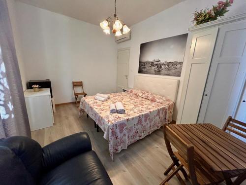 a small room with a bed and a table at Apt Versilia in Viareggio