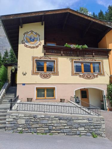 a house with a stone staircase in front of it at Haus Bernkogel in Sankt Johann im Pongau