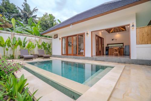 a swimming pool in the backyard of a house at Arca Jungle View Luxury Villa Ubud in Ubud