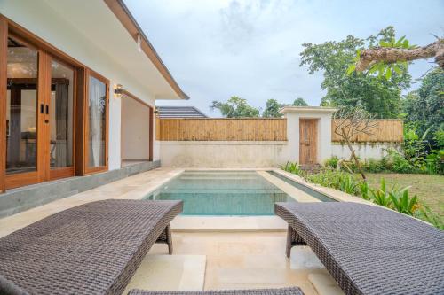 a swimming pool in the backyard of a house at Arca Jungle View Luxury Villa Ubud in Ubud