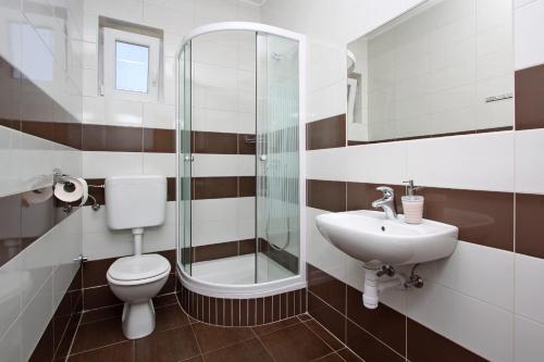 a bathroom with a toilet sink and a shower at Apartments Jasmina in Novalja
