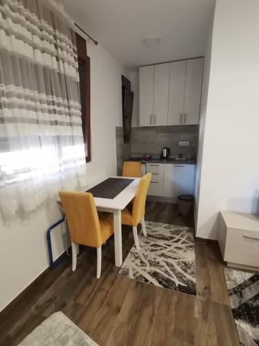 a kitchen with a table and chairs in a room at apartmani Daria in Cetinje
