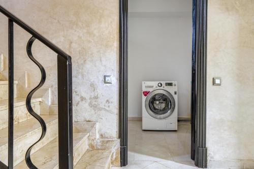 a washer and dryer in a room with a staircase at Villa 33 haut standing Avec piscine et Hammam in Tangier