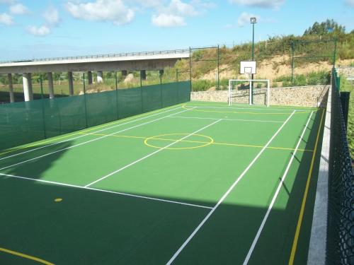 a tennis court with a net on top of it at Lisotel - Hotel & Spa in Leiria