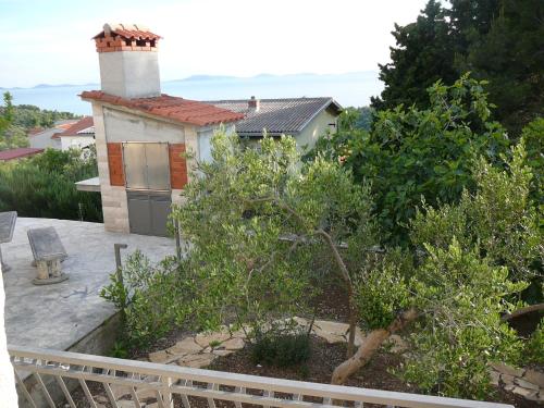 a view of a house from the balcony at Murter Inn in Murter