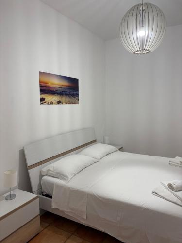 a bedroom with two beds and a pendant light at Nova Lux in Custonaci