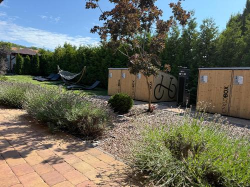 a garden with a hammock and some bushes and trees at Apartmány Přítluky in Přítluky