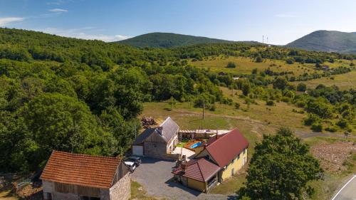 an aerial view of a house in the mountains at Old house Rustica with pool, jacuzzi and tavern - Valincic in Brinje