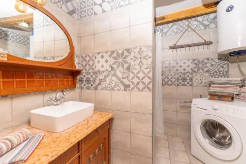 a bathroom with a sink and a washing machine at Old house Rustica with pool, jacuzzi and tavern - Valincic in Brinje