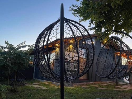 a wire basket on a pole in front of a house at 317 Accommodation in Ucea de Sus