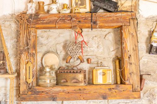 a wooden shelf with various items on a wall at Old house Rustica with pool, jacuzzi and tavern - Valincic in Brinje