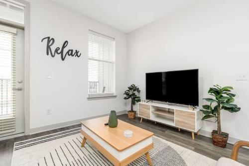 a white living room with a flat screen tv at Affordable Private Room in Whitestown