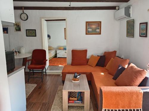 a living room with a couch and a table at centuries old Ethno House Đurović in Virpazar