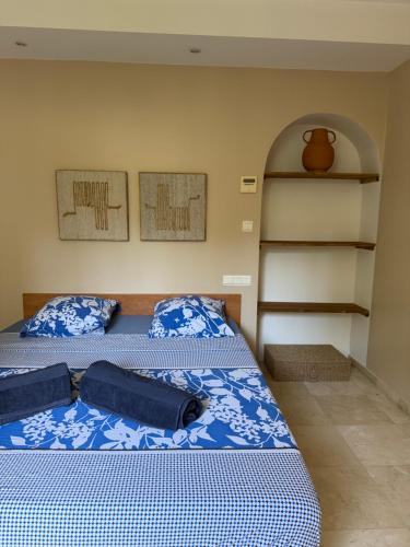 a bedroom with two beds with blue and white sheets at La Villa Saint Jean BAS DE VILLA in La Ciotat