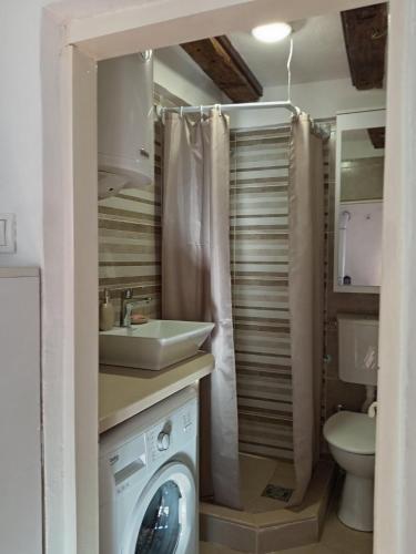 a bathroom with a sink and a washing machine at centuries old Ethno House Đurović in Virpazar