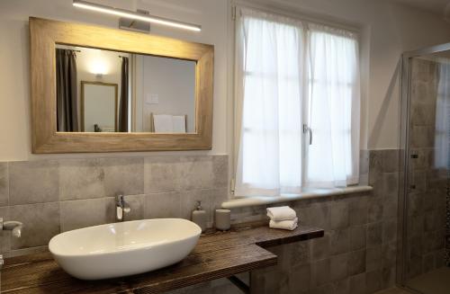 a bathroom with a white sink and a mirror at il Frutteto in Pietrasanta