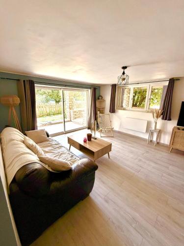 un salon avec un canapé et une table dans l'établissement Eaux Iris - Studio avec Jardin privatisé proche Casino, à La Roche-Posay