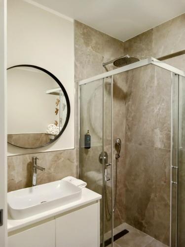 a bathroom with a sink and a shower at Dimitris Residence in Tivat