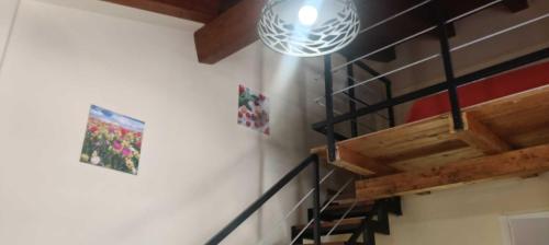 a room with a staircase and a light on the wall at Bluiaia case vacanze tropea in Caria