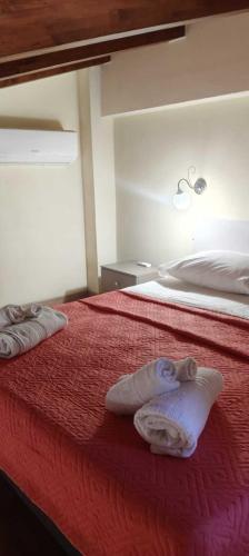 a bedroom with a bed with two towels on it at Bluiaia case vacanze tropea in Caria