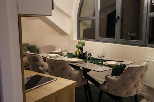 a dining room with a table and chairs with glasses at Om relax in Prijedor
