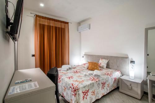 a hotel room with a bed and a desk at Monte Monaco B&B in San Vito lo Capo