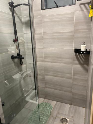 a shower with a glass door in a bathroom at Sure Stay Homes in Gatunga