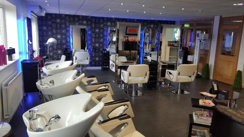 a salon with sinks and chairs in a room at Bells Hotel in Coleford