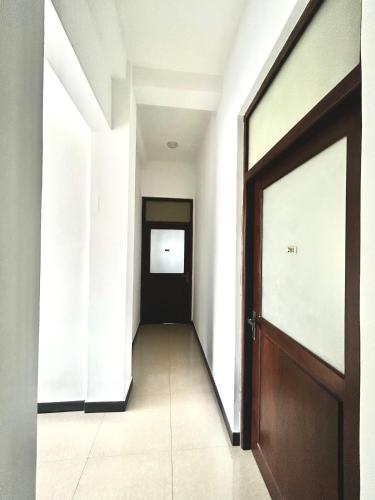 an empty hallway with a wooden door and a doorway at Terrace Kandy in Kandy