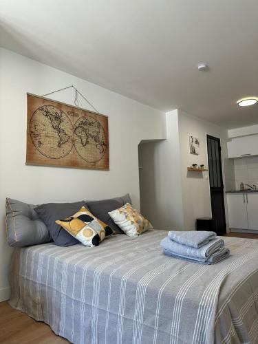 a bedroom with a bed and a map on the wall at Logement 7 parking gratuit in Poitiers