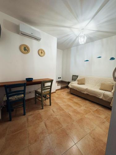 a room with a bed and a desk and a table at Dimora Lilium in Otranto