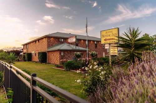 a brick building with a sign in front of it at Scone Motor Inn & Apartments in Scone