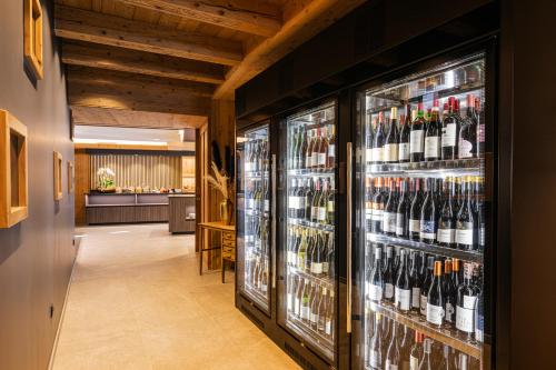 a room filled with lots of bottles of wine at Moar's Hotel in Valdaora