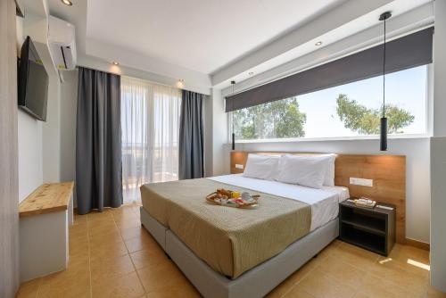 a bedroom with a large bed and a large window at City Gate Hotel Airport Thessaloniki in Thessaloniki