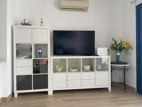 a white entertainment center with a television on top at Sol Y Mar in Puerto del Carmen