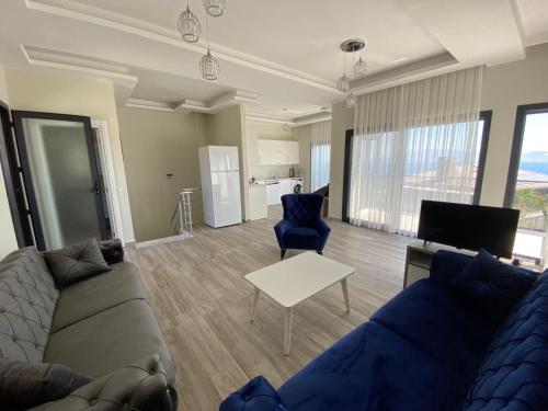 a living room with a couch and a table at Kaptan Villas in Cesme