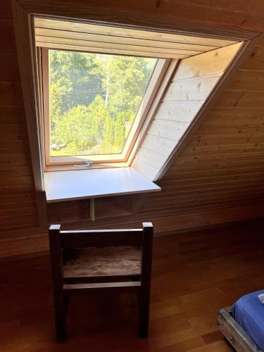 a window in a room with a bench under it at Norwegian saunahouse in Haapse